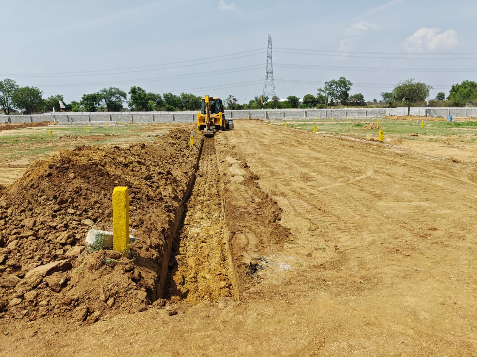 Fortune Avenue site — compound wall and entrance arch poles under construction